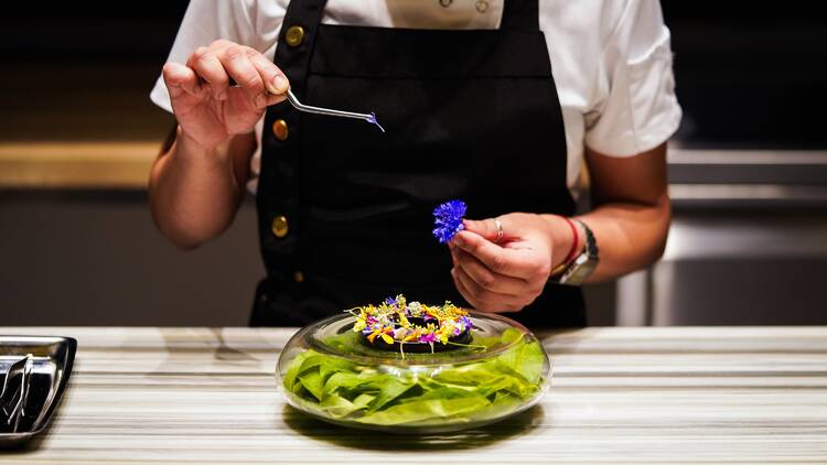 Dish representing the bitter flavor with avocado, chocolate, peach leaf and cocoa nibs 