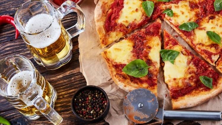 Two glasses of beer and pizza
