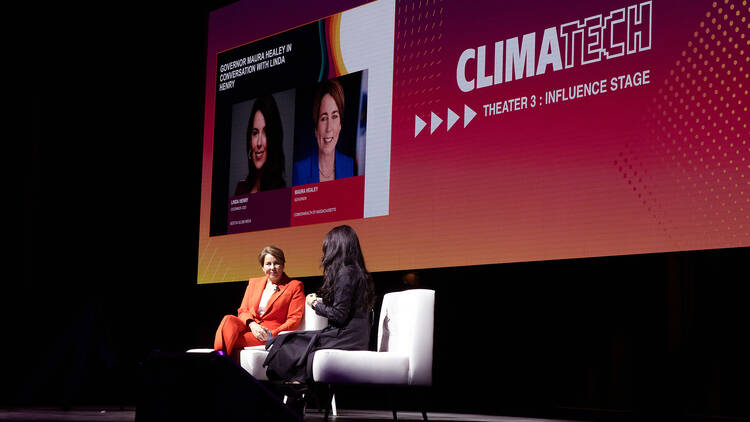 two women seated on stage two women seated on stage