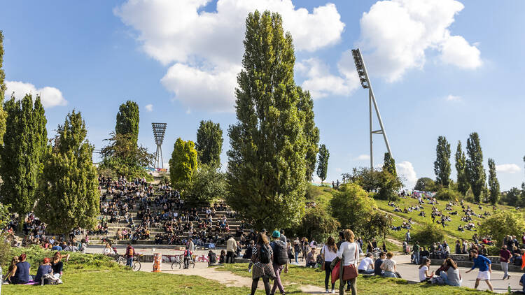 People enjoy sunny Sunday at Mauerpark. Situated in "death strip" of Berlin Wall (Mauer) Mauerpark is now a social, cultural and artistic center of Berlin