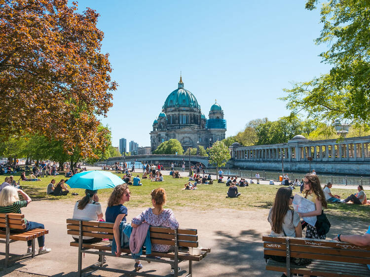 People in public park on a sunny day near Museum Island and Berlin Cathedral