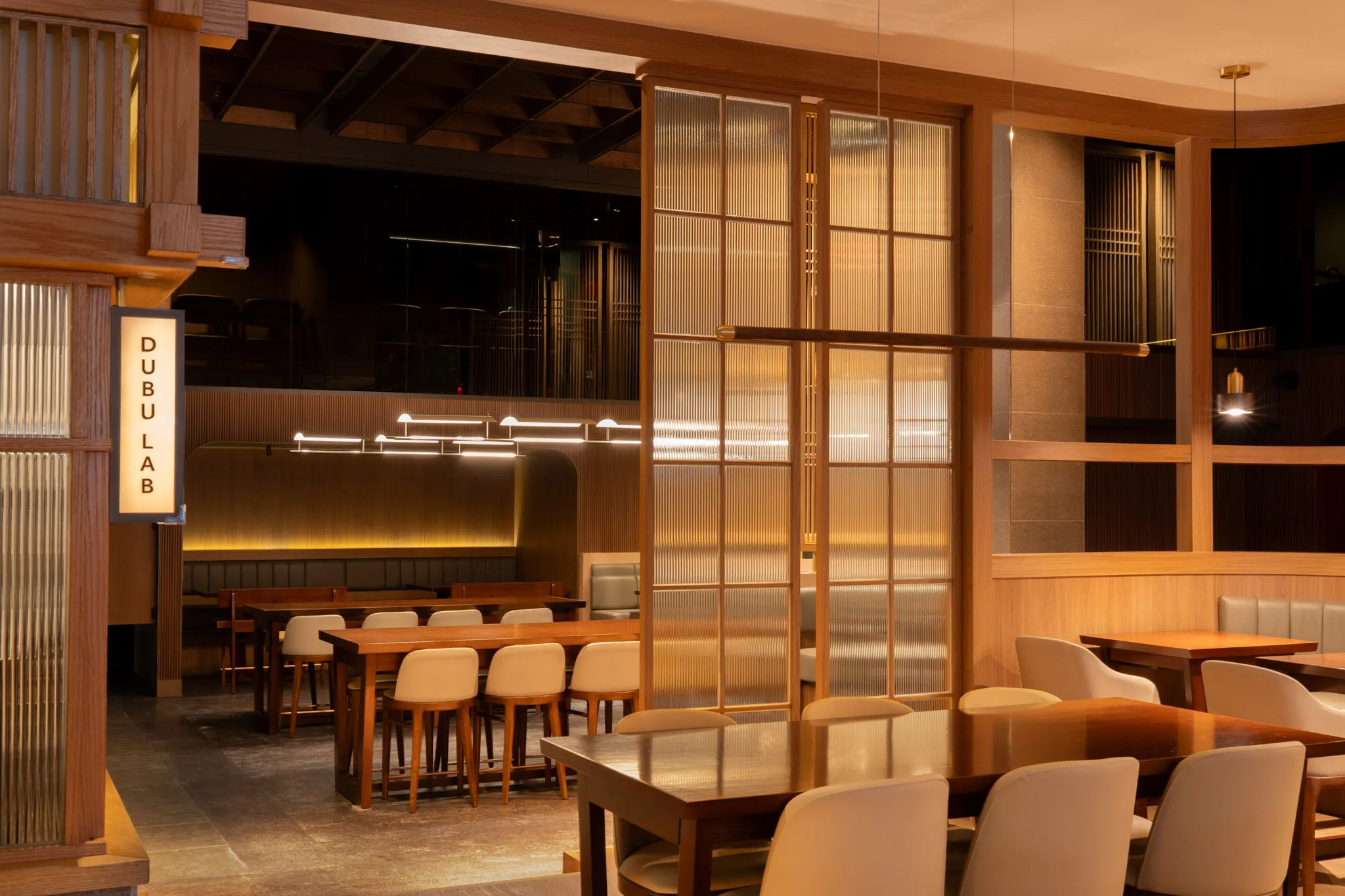 Wooden interior with glass panels and a sign that read "DUBU LAB"