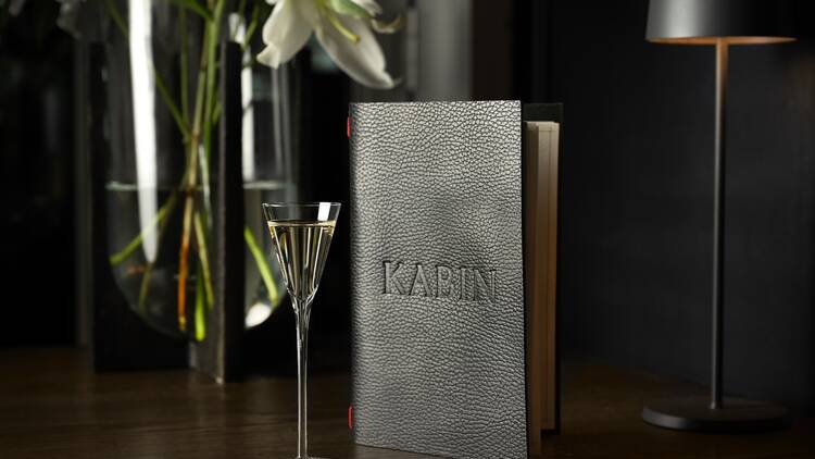 A small cocktail and a booklet that says "Kabin"
