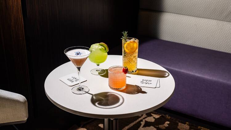 A table in a bar with colourful cocktails