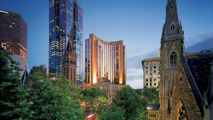 The exterior of the Grand Hyatt Hotel in the evening.