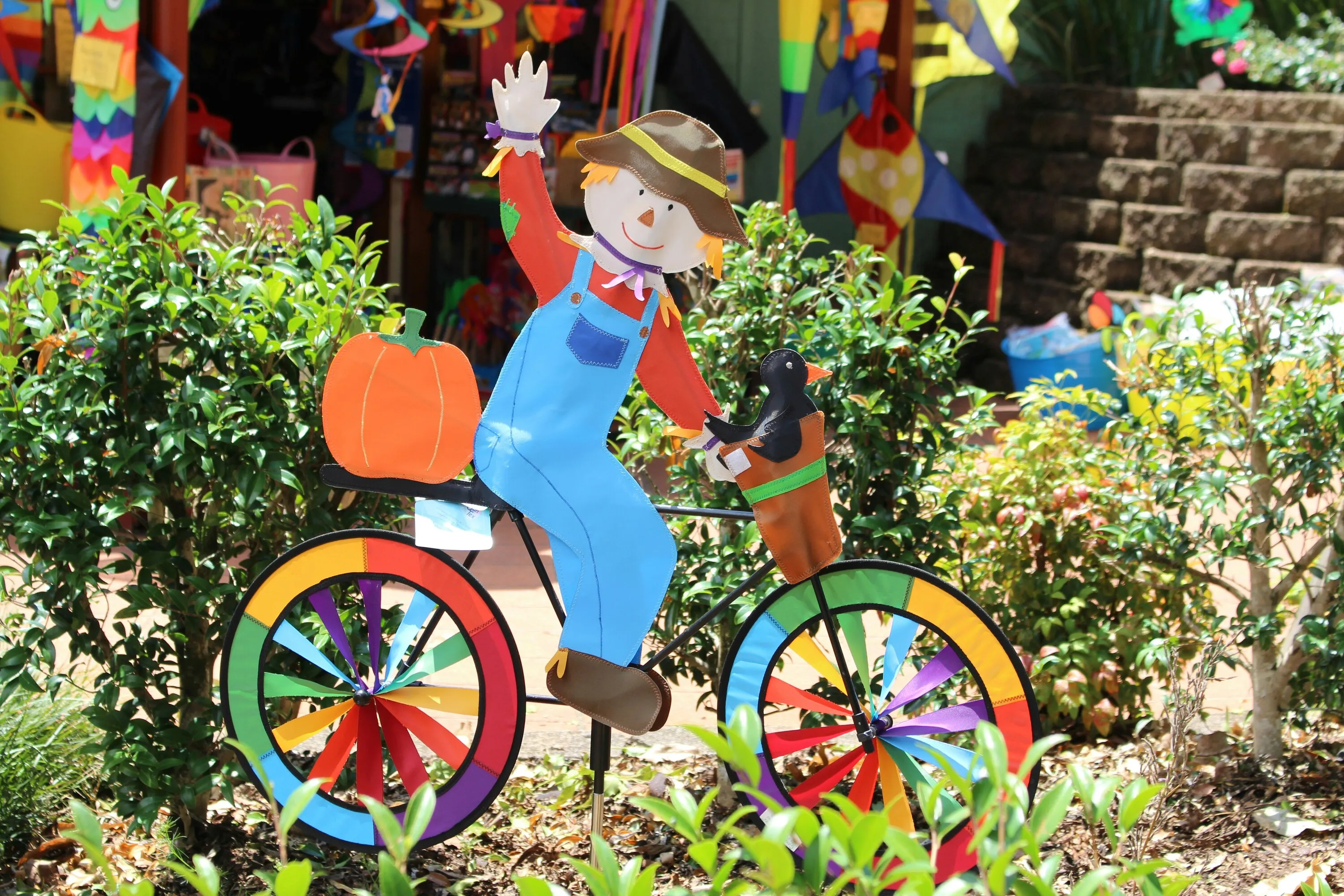 Garden clown riding bike in garden