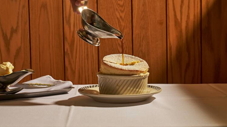 The pancake souffle with a pour of syrup