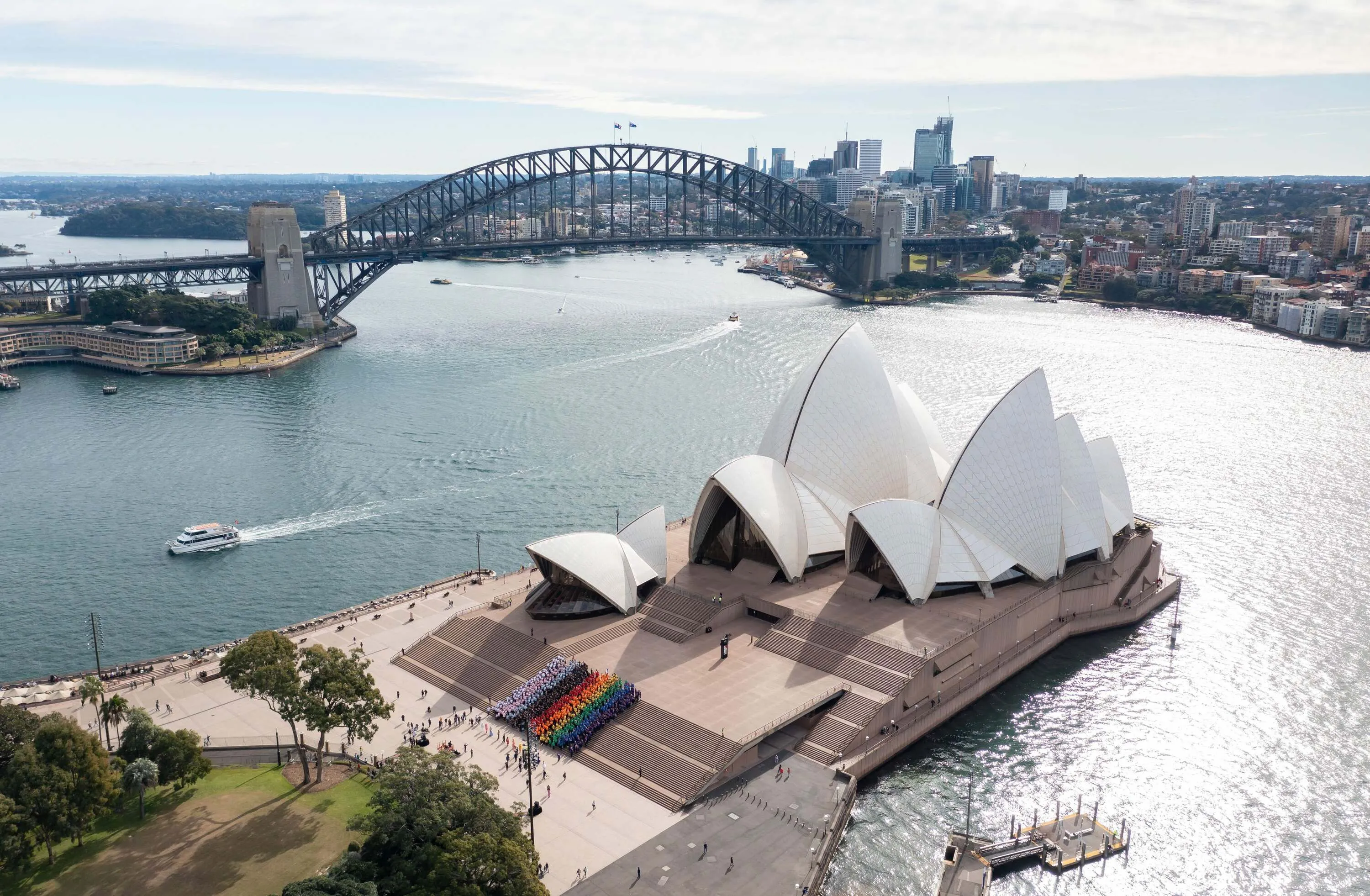 Sydneysiders created a human Progress Flag on the steps of the Sydney Opera House.