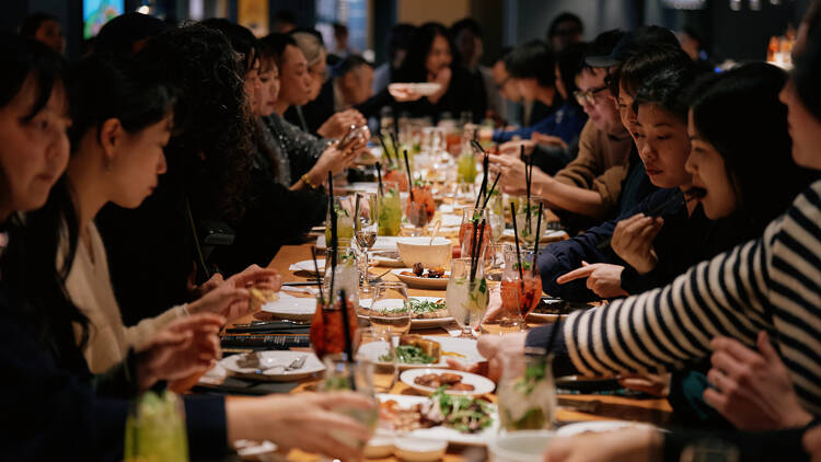 Tables full of food and people at Time Out Market Osaka