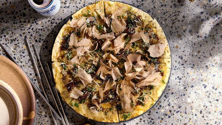 Eel pizza on a black and white table