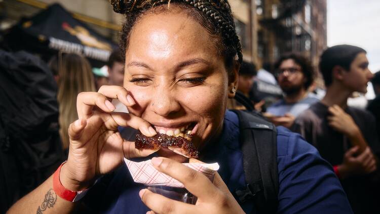 A person eating a rib