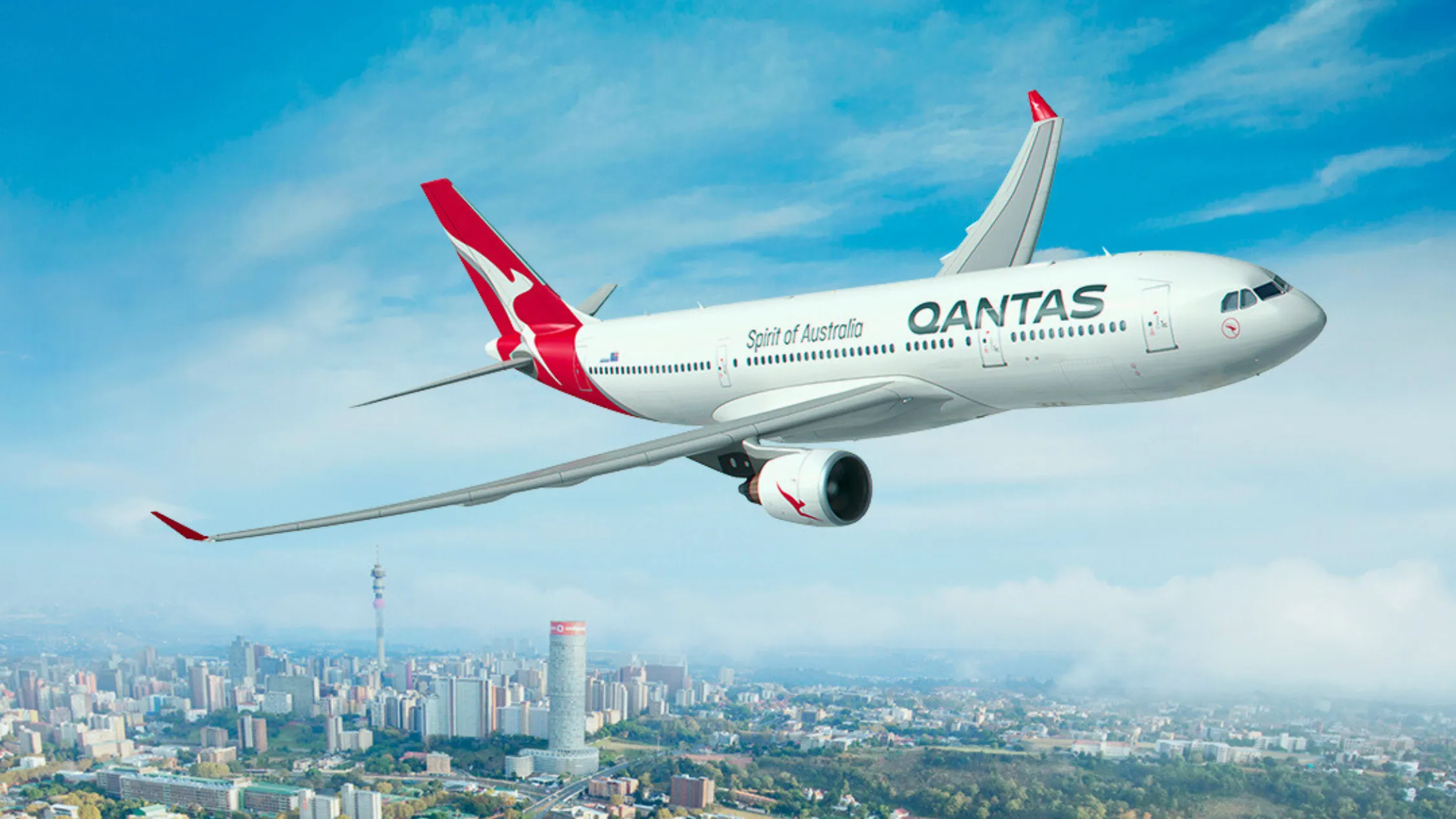 Qantas plane flying in blue sky