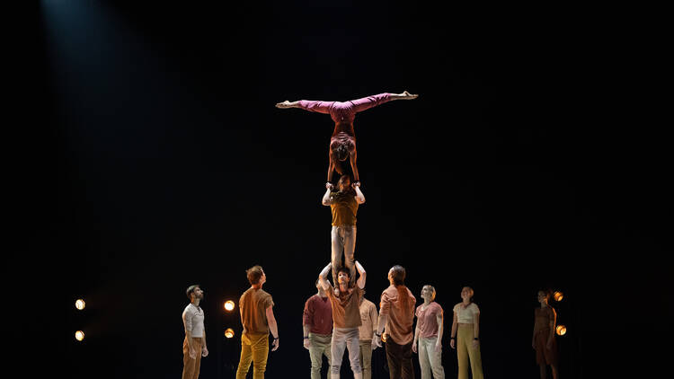 A group of circus performers on stage.