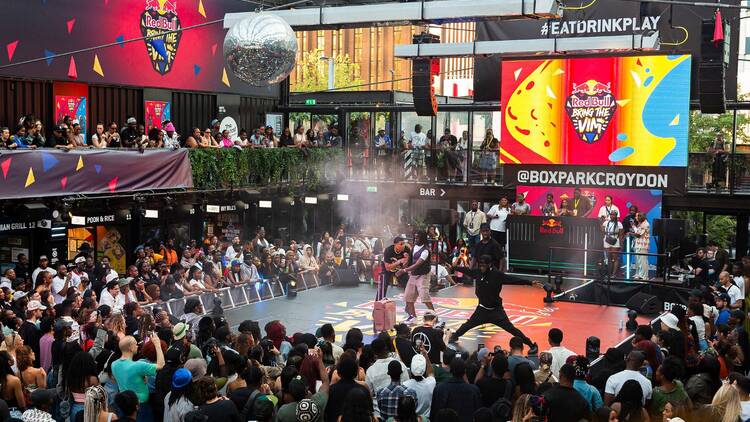 Crowds watching two performers on stage at Red Bull Bring the Vim at Boxpark Croydon