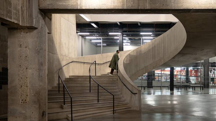 A man climbs concrete staircase at an empty Tate Modern