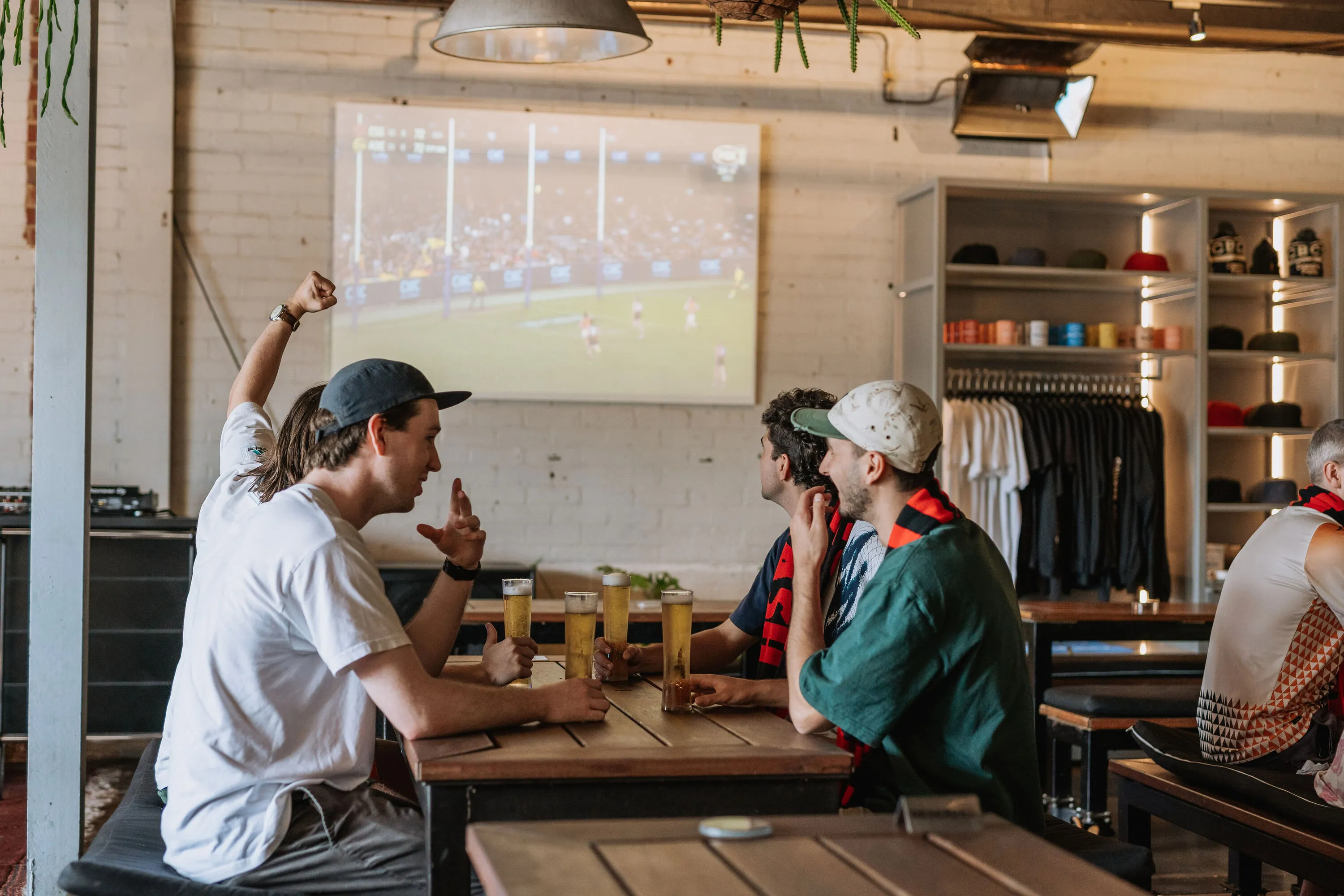 Group of friends drinking beer at CBCo's Port Melbourne brewery.