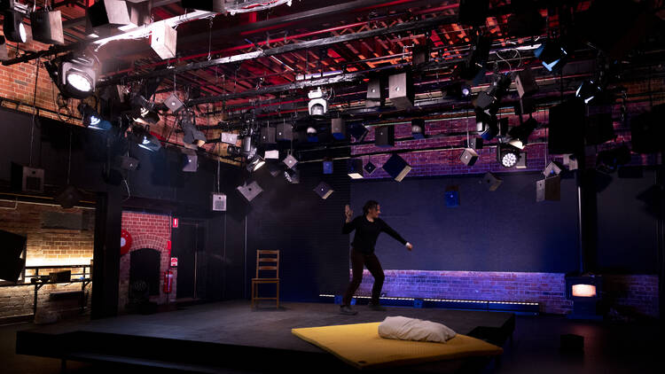 Paula Arundell throwing something on stage in 'The Birds'.