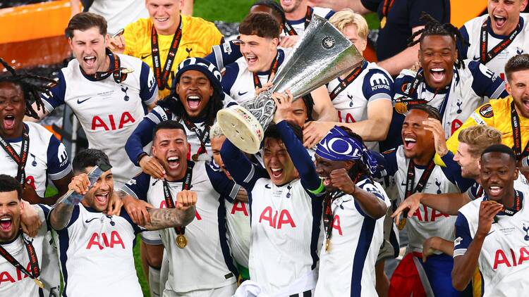 Son lists the Europa League trophy among Tottenham Hostpur teammates after winning against Manchester United in Bilbao