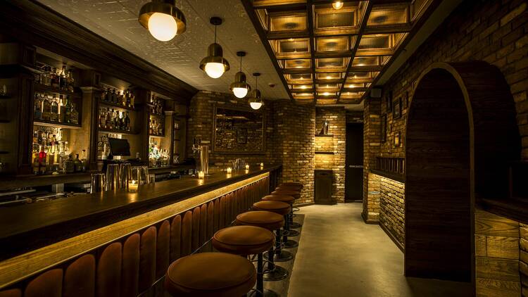 A long golden bar with bar stools