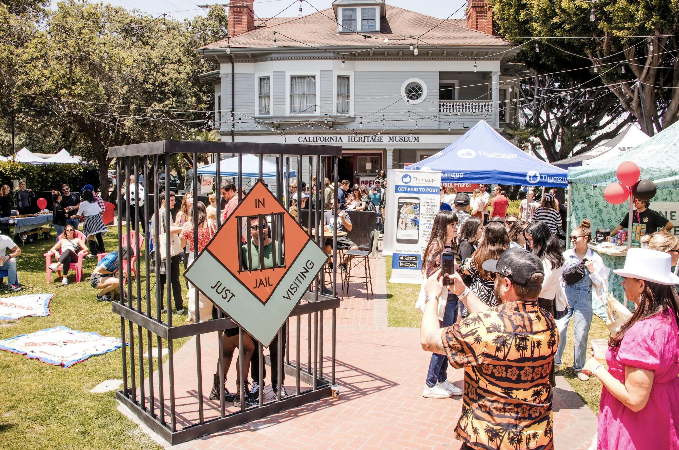 People pose in a fake jail at MAINopoly.