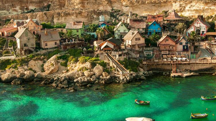 Green sea fringed by historical town