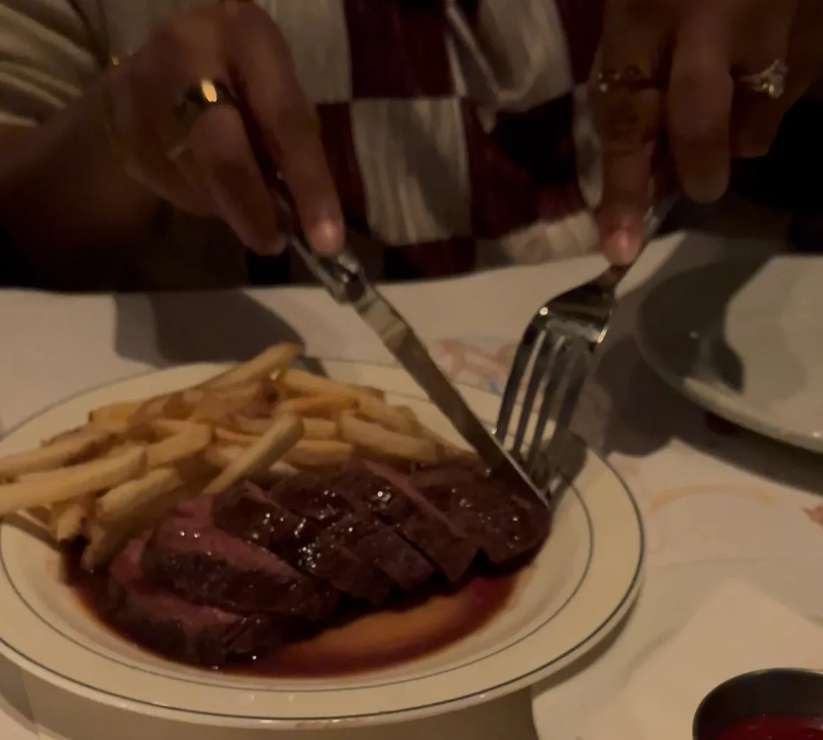 A person cutting steak