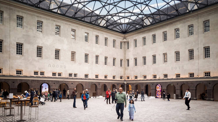 Tourists visit the beautiful entrance hall of the National Maritime Museum (Scheepvaartmuseum) in Amsterdam, the Netherlands, on November 6, 2019