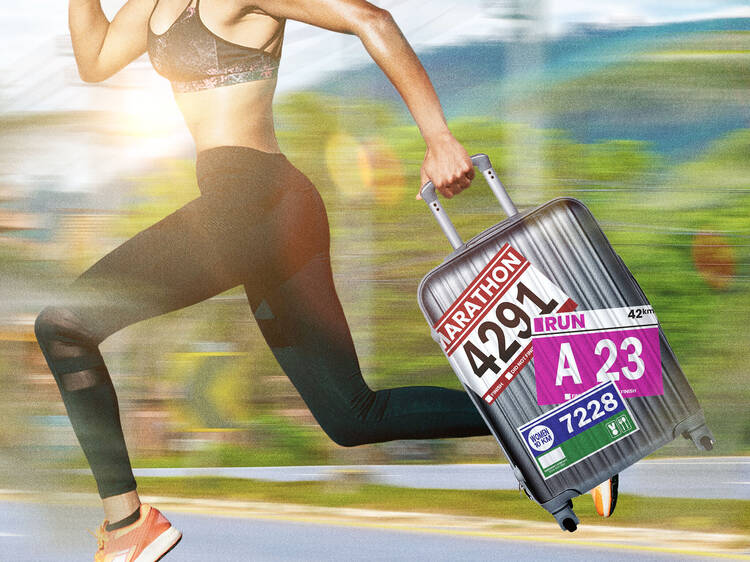 A runner carrying a suitcase with a blurred background