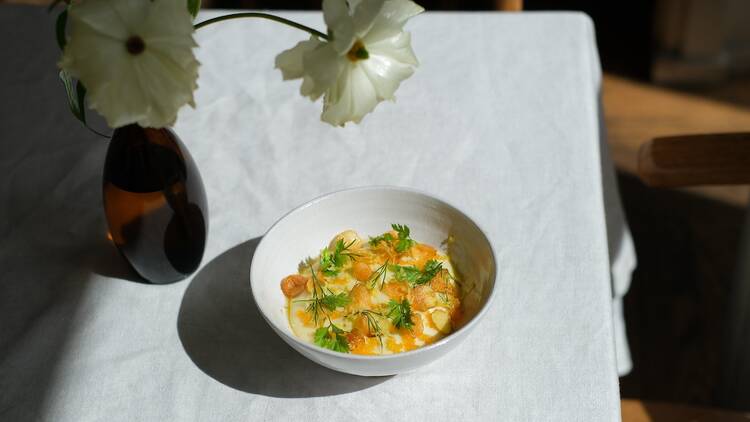 A dish with fennel and potates inside a white dish