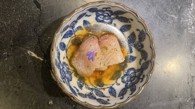 Saishin A blue and white bowl with thinly sliced fish