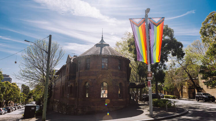 Outside of brick building with rainbow flags