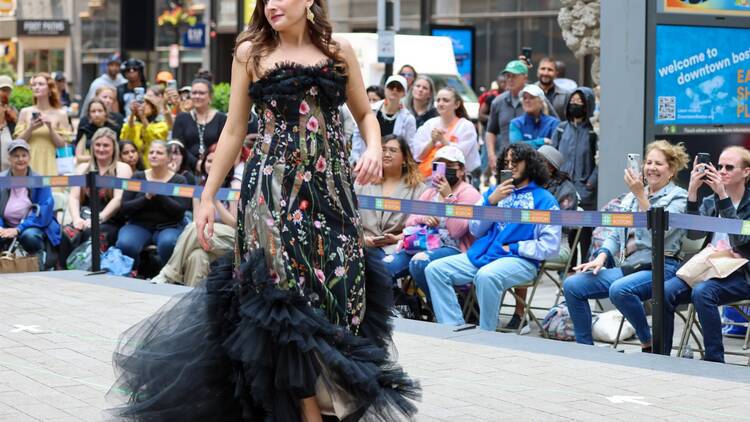 woman on runway in a gown woman on runway in a gown