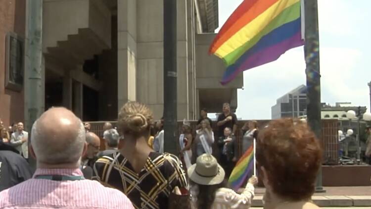 Pride flag being raised