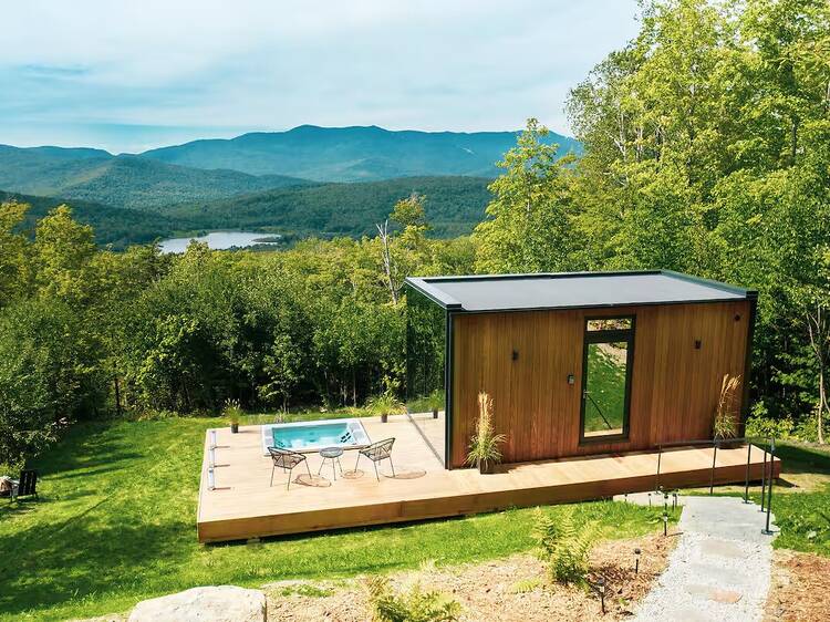 luxury glass tiny house on top of hill
