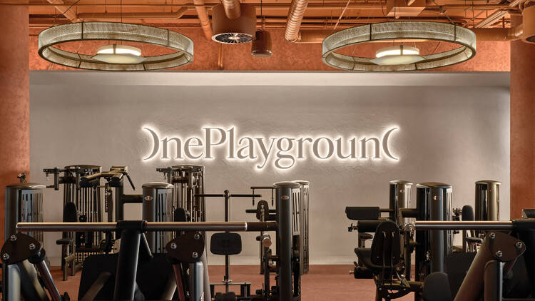 A gym with a sign saying One Playground