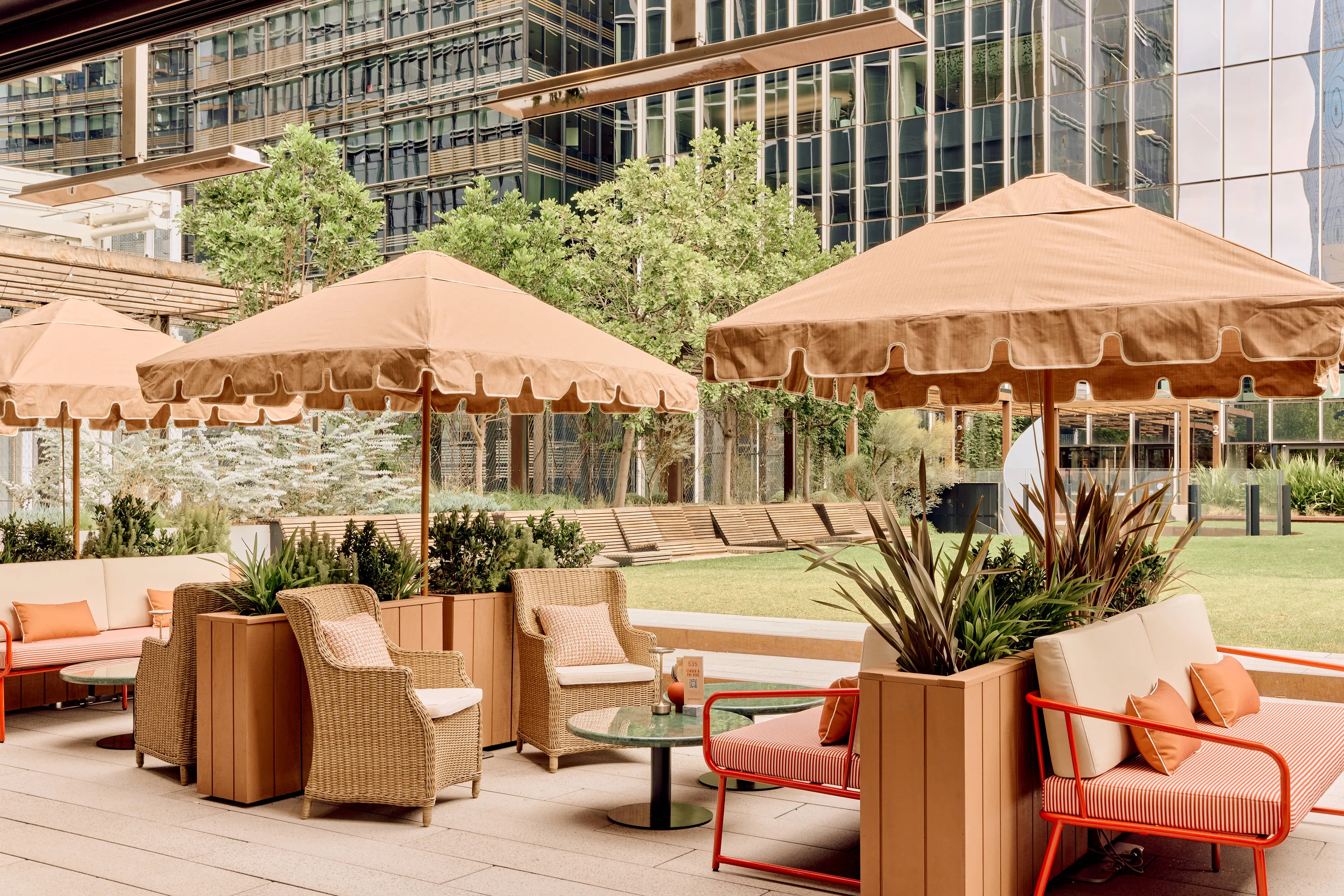 Sofa seating under umbrellas at Quarterhouse.