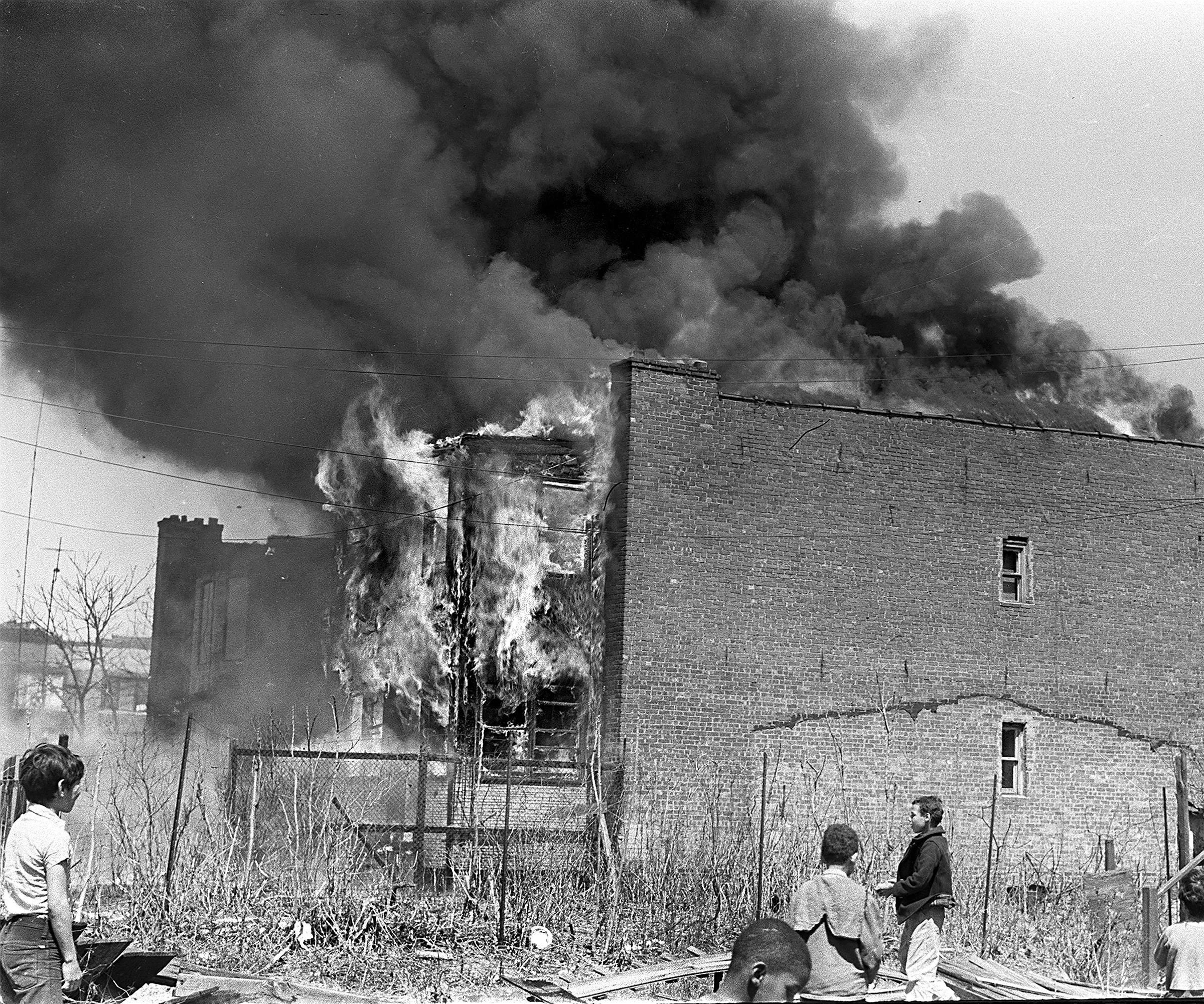 Kids look at a building on fire, West 30th Street, 1969