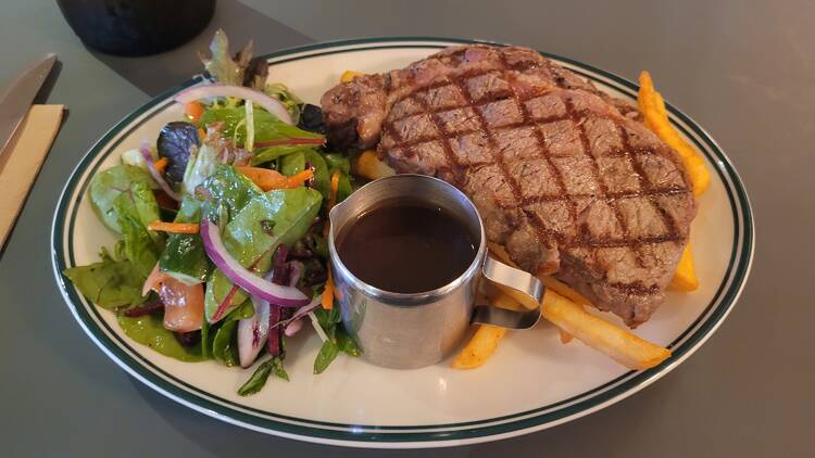 Steak and chips and salad on a plate