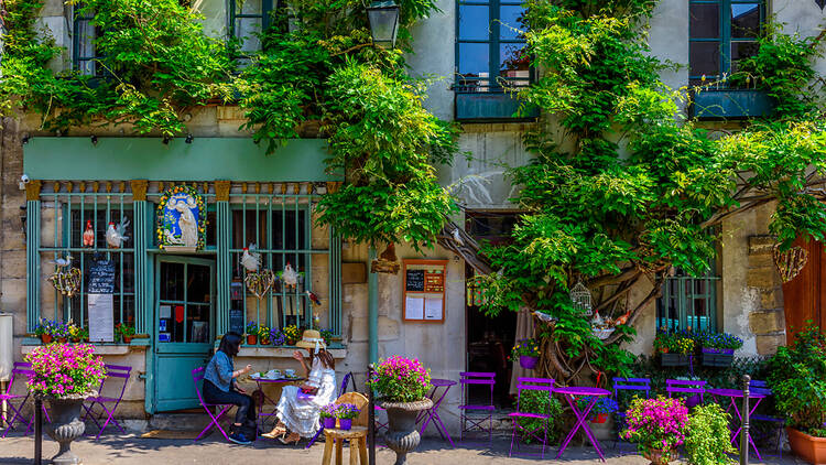 People talking outside a French cafe
