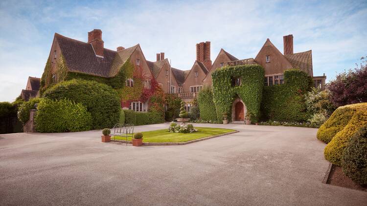 The front entrance, driveway and manicured gardens of Mallory Court Hotel and Spa, in Leamington Spa, Warwickshire.