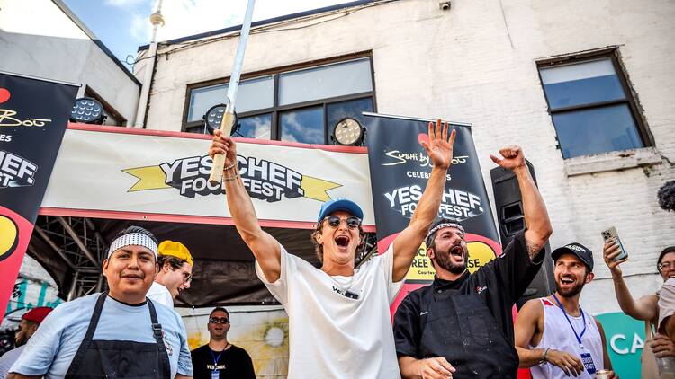Jack Goldburg holding a knife in the air