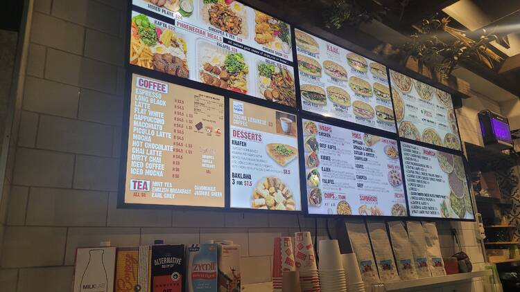 A menu on the wall with lots of food menus