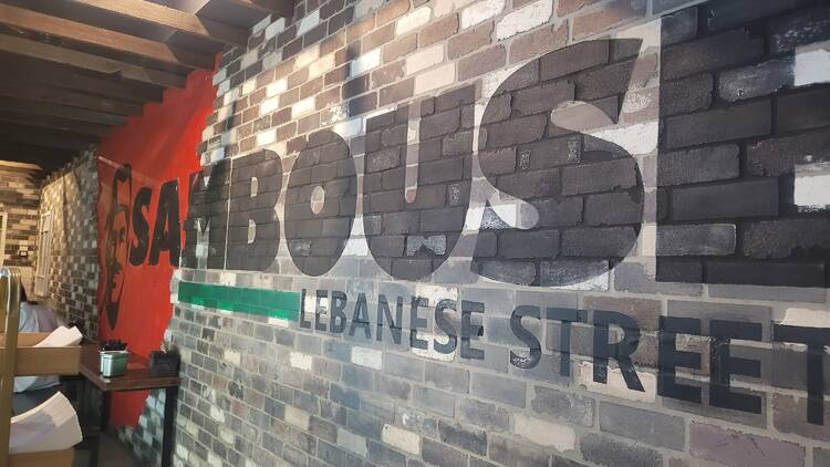A sign on a brick wall