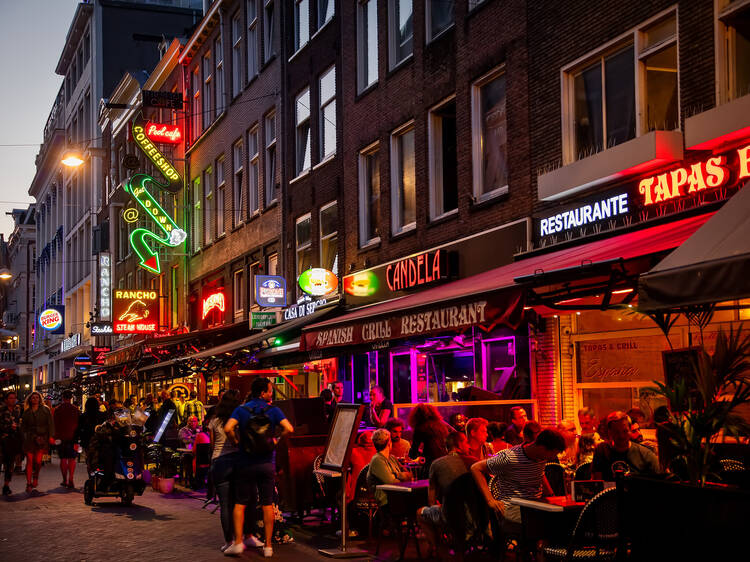 Colorful night lights with music entertainment and bars in walking street Korte Leidsedwarsstraat at Amsterdam. is a busy tourist street.