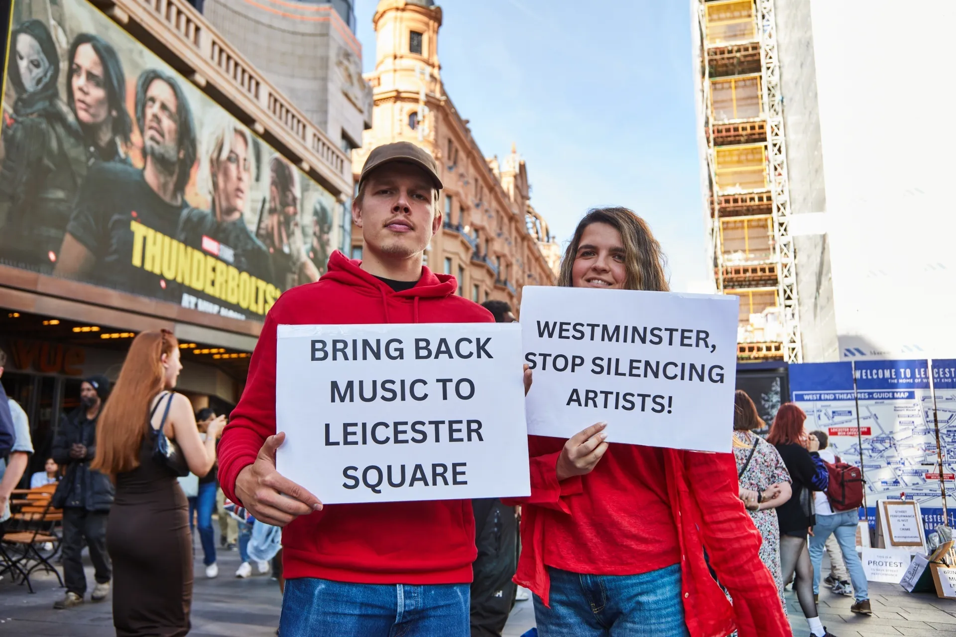 Protestors with signs at busker rally