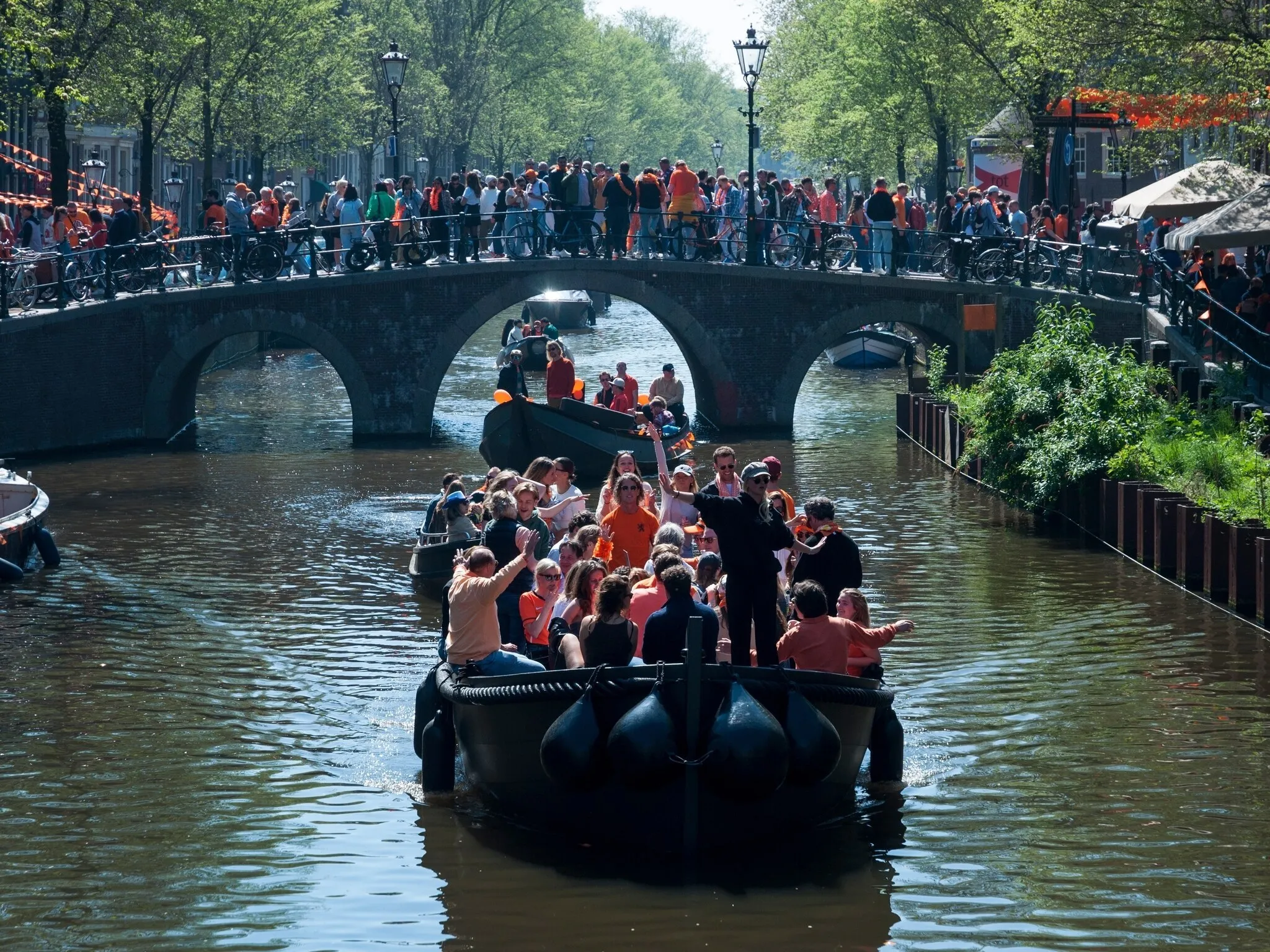 Kingsday celebrations.People dressed in orange celebrating the King's birthday with parties on the streets and canals of Amsterdam