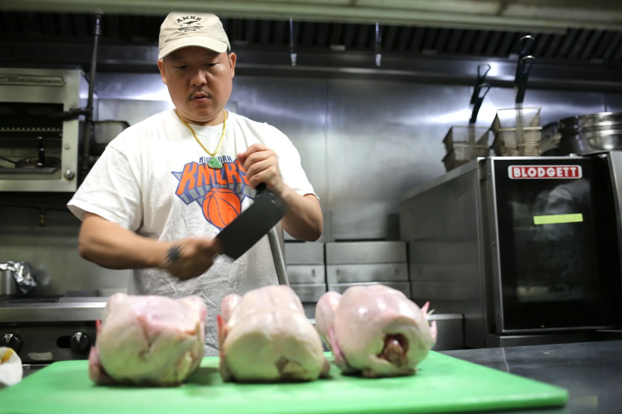 Eddie Huang in the kitchen with a knife