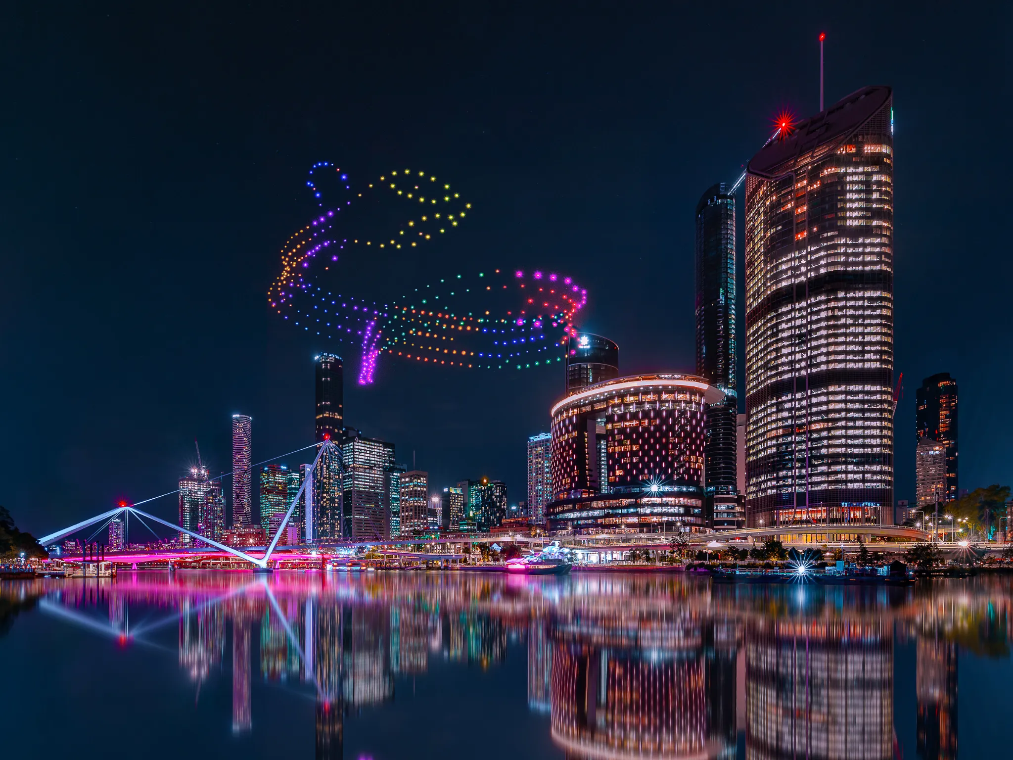 Drone show above city skyline at night