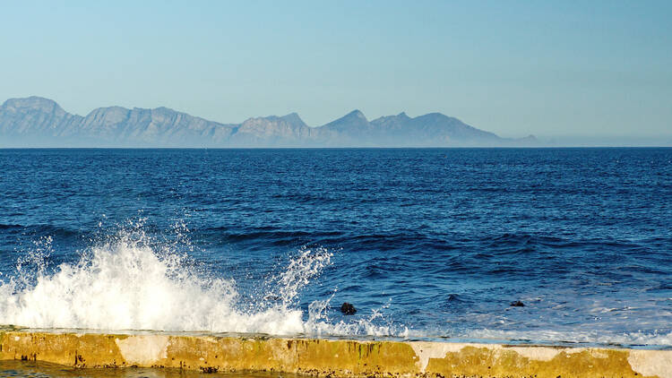 Waves breaking on the wall of a sea pool in Kalk Bay