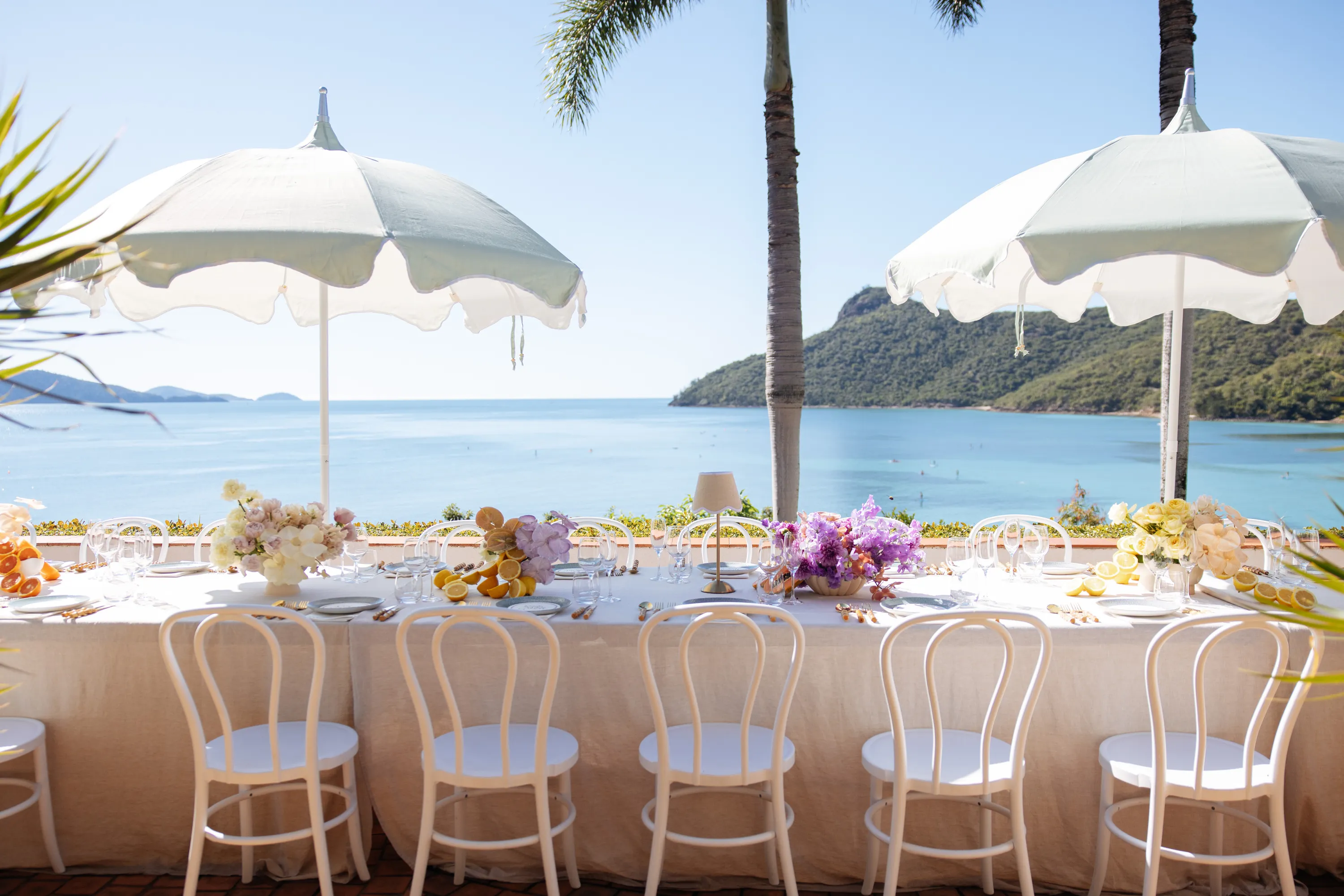Table set for long lunch by water